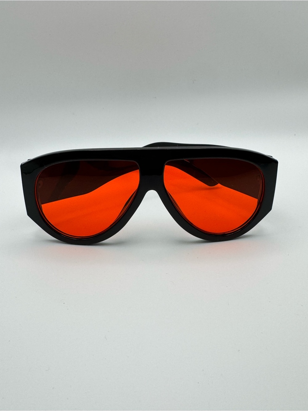Glossy Black Sunglasses with Vivid Orange Lenses